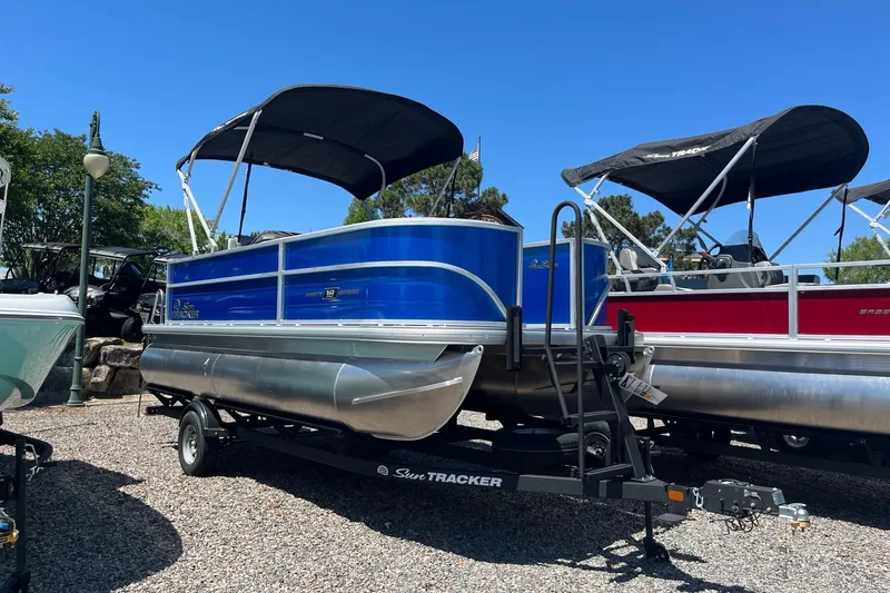 The Image of 2026 Sun Tracker Party Barge 18 DLX pontoon boat with canopy on trailer. - 0
