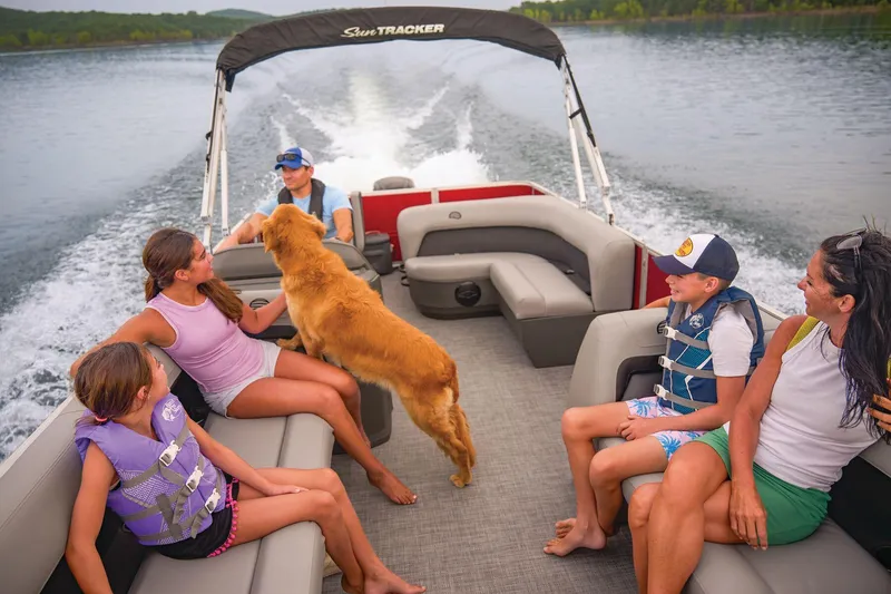 Slide: The Image of 2026 Sun Tracker Party Barge 18 DLX interior seating with cup holders, gray upholstery. - 6