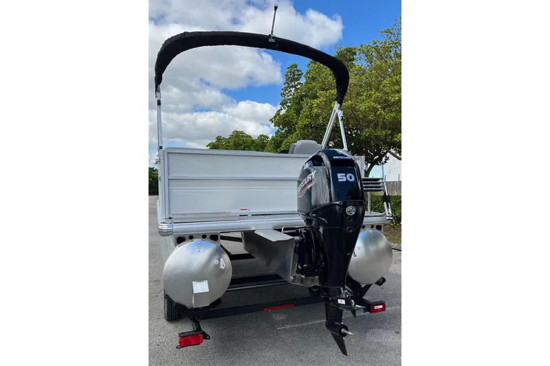 Slide: The Image of 2026 Sun Tracker Party Barge 16 DLX with Mercury 50 outboard motor, rear view. - 5