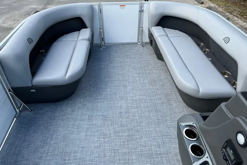 Slide: The Image of 2026 Sun Tracker Party Barge 16 DLX interior with gray seating and cup holders. - 52