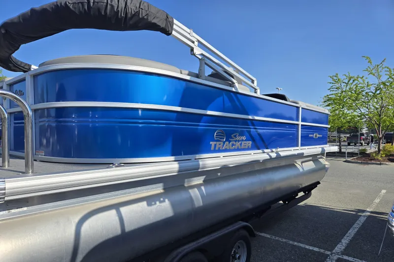 Slide: The Image of 2026 Sun Tracker Party Barge 22 DLX pontoon boat in a parking lot. - 6