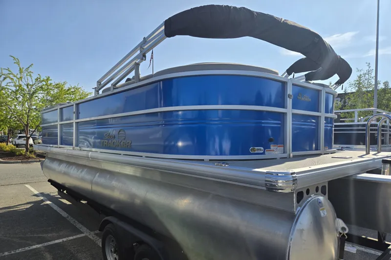 Slide: The Image of 2026 Sun Tracker Party Barge 22 DLX pontoon boat in a parking lot. - 8