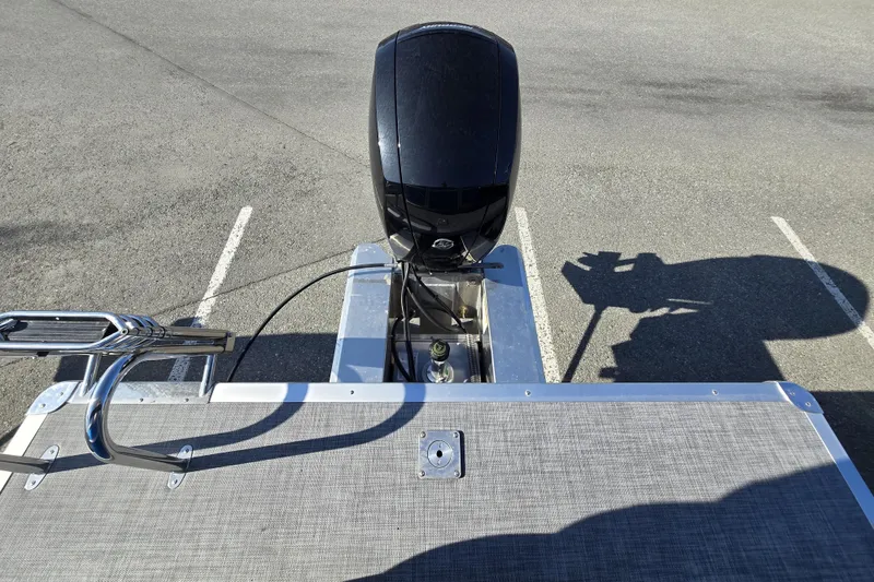 Slide: The Image of 2026 Sun Tracker Party Barge 22 DLX pontoon boat with outboard motor in parking lot. - 12