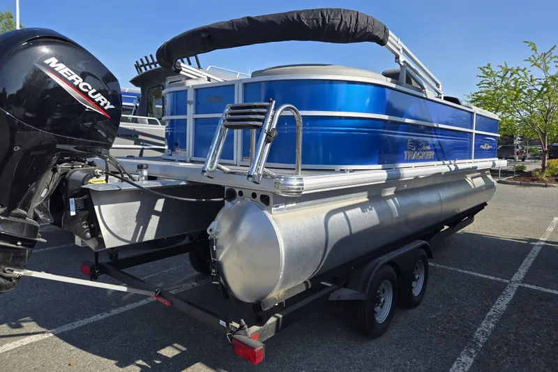 Slide: The Image of 2026 Sun Tracker Party Barge 22 DLX pontoon boat with Mercury engine on trailer. - 5