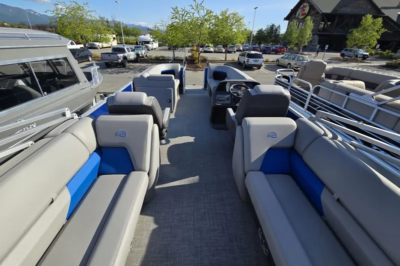 Slide: The Image of 2026 Sun Tracker Party Barge 22 DLX pontoon boat with spacious seating in a parking lot. - 11