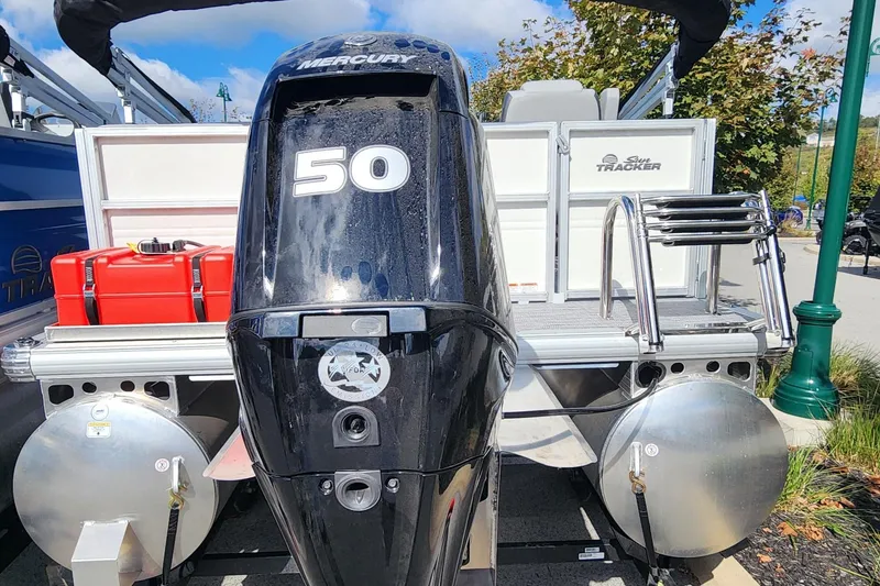 Slide: The Image of 2026 Sun Tracker Party Barge 16 DLX with Mercury 50 outboard motor, docked outdoors. - 6