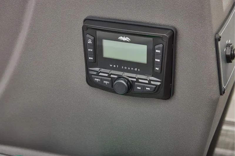 Slide: The Image of 2026 Sun Tracker Party Barge 16 DLX steering console with seating and cup holders. - 22