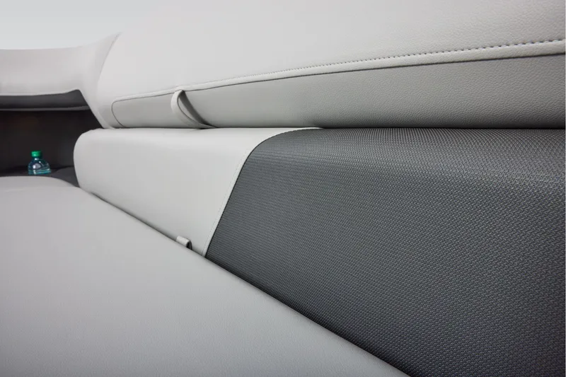 Slide: The Image of Sun Tracker Party Barge 20 DLX 2026 boat seating with cup holders and red accent. - 24