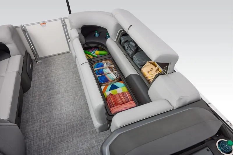 Slide: The Image of 2026 Sun Tracker Party Barge 20 DLX interior with plush seating and steering console. - 22