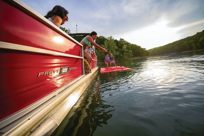 Slide: The Image of 2026 Sun Tracker Party Barge 18 DLX interior seating with storage compartment. - 12