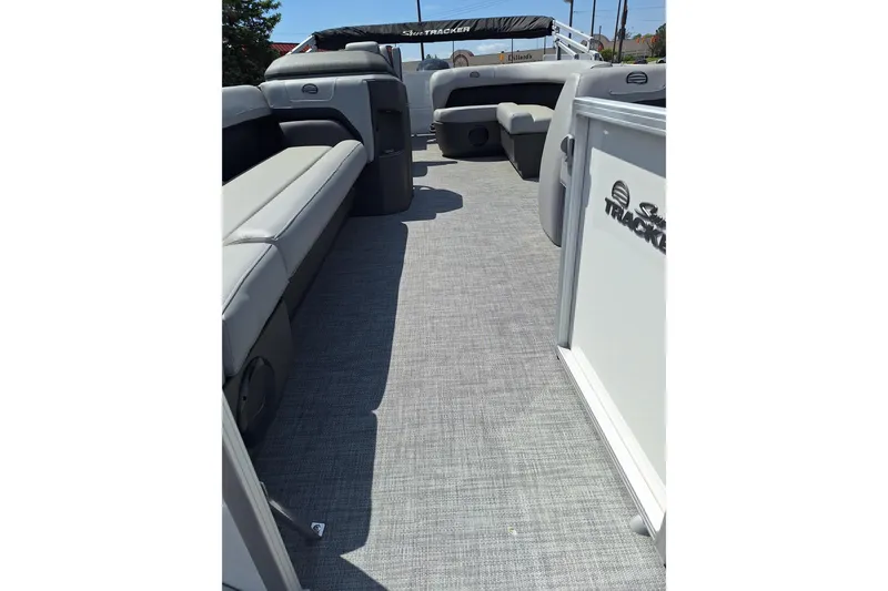 Slide: The Image of 2026 Sun Tracker Party Barge 18 DLX interior with gray seating and flooring. - 3