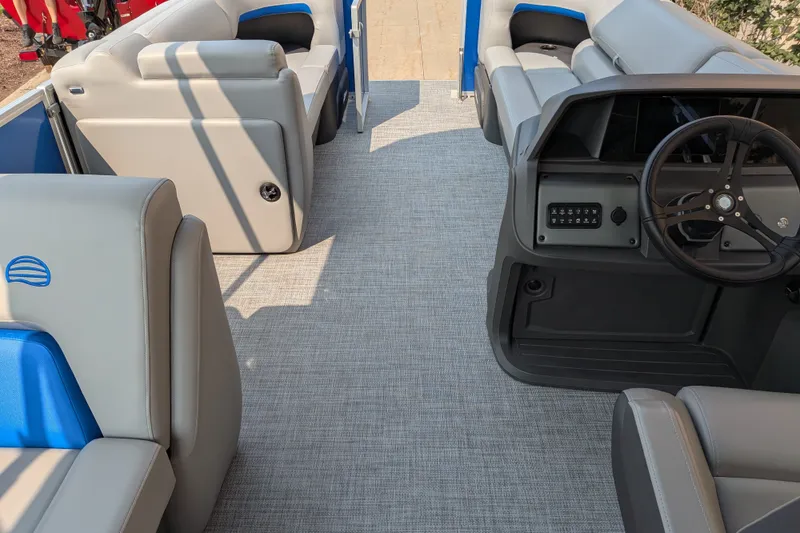 Slide: The Image of Interior of 2026 Sun Tracker Party Barge 20 DLX with gray seating and steering console. - 82