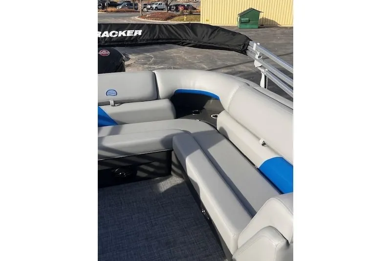 Slide: The Image of 2026 Sun Tracker Party Barge 20 DLX with gray and blue seating on deck. - 69