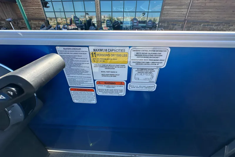 Slide: The Image of Safety and capacity labels on a 2026 Sun Tracker Party Barge 22 DLX boat. - 49