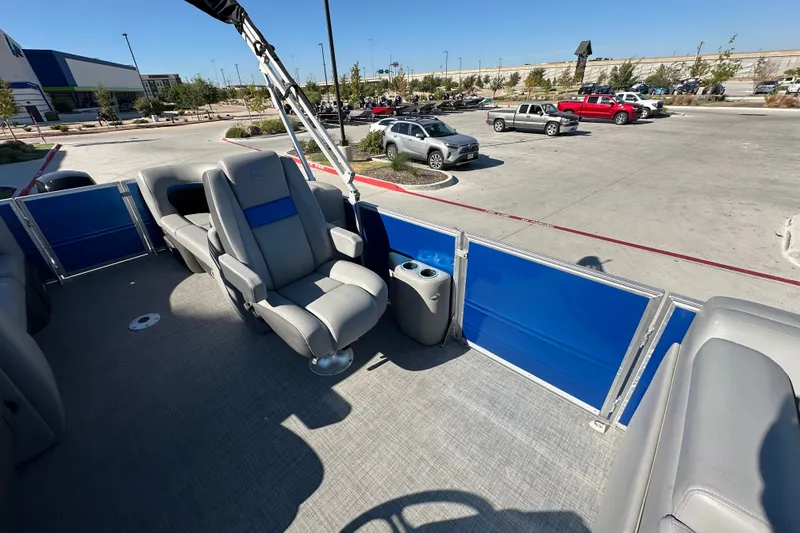 Slide: The Image of 2026 Sun Tracker Party Barge 22 DLX interior with comfortable seating and blue paneling. - 41