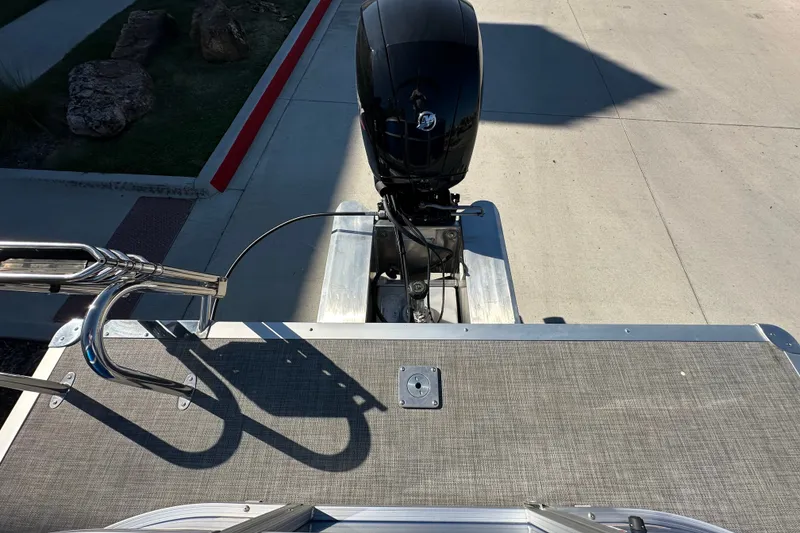 Slide: The Image of 2026 Sun Tracker Party Barge 22 DLX pontoon boat with outboard motor and ladder. - 45