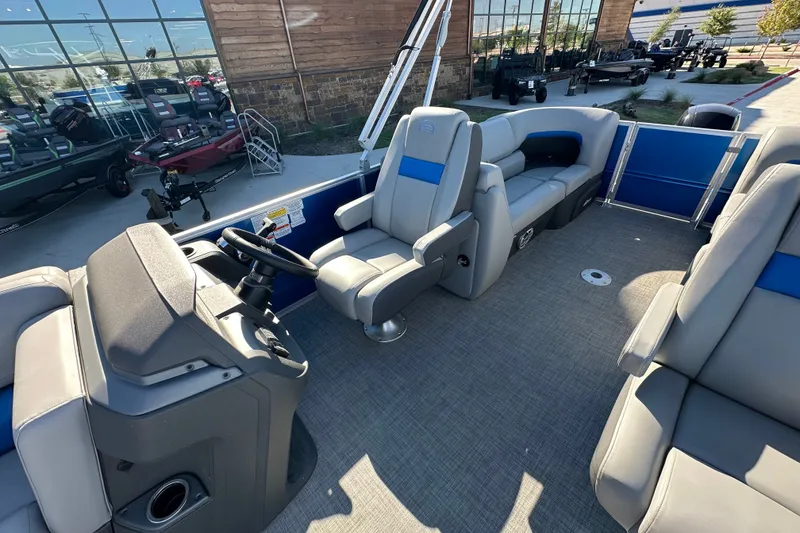 Slide: The Image of 2026 Sun Tracker Party Barge 22 DLX interior with plush seating and modern helm. - 42