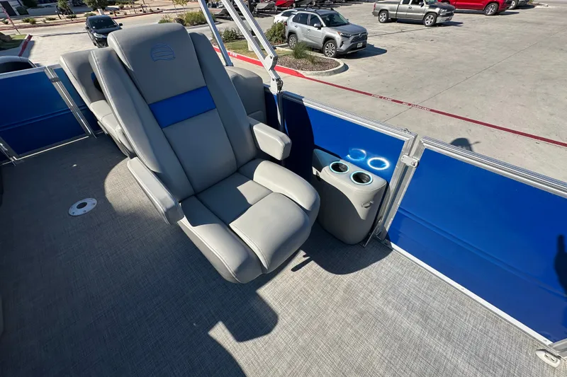 Slide: The Image of 2026 Sun Tracker Party Barge 22 DLX interior with comfortable seating and cup holders. - 51