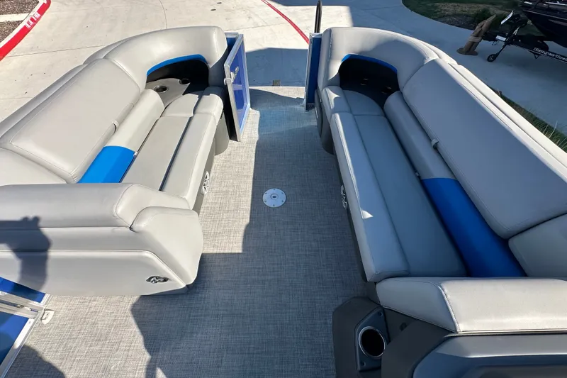 Slide: The Image of 2026 Sun Tracker Party Barge 22 DLX interior with gray and blue seating. - 50