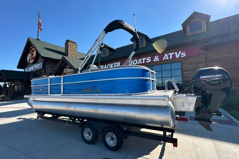 The Image of 2026 Sun Tracker Party Barge 22 DLX pontoon boat with Mercury engine at outdoor store. - 26