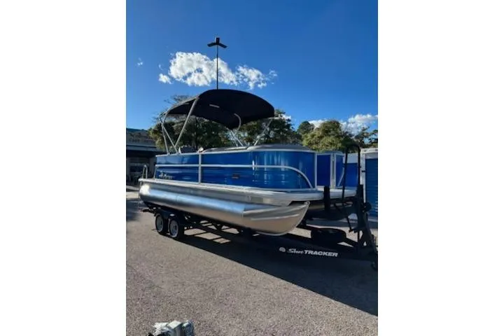 The Image of 2026 Sun Tracker Party Barge 20 DLX pontoon boat on trailer, blue exterior. - 0