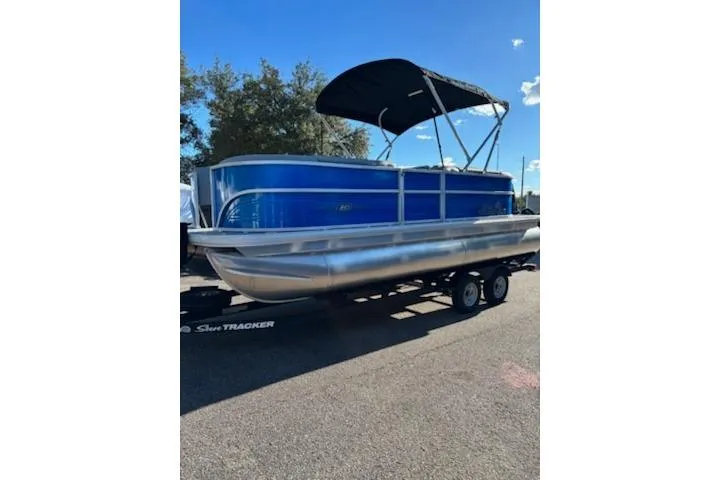 Slide: The Image of 2026 Sun Tracker Party Barge 20 DLX pontoon boat with blue exterior on trailer. - 4