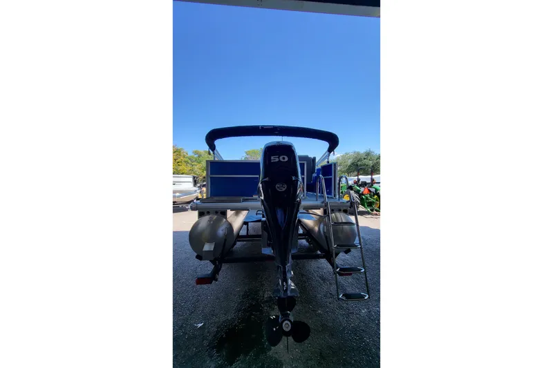 Slide: The Image of 2026 Sun Tracker Party Barge 20 DLX pontoon boat with outboard motor and ladder. - 5