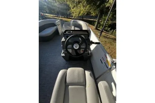 Slide: The Image of 2026 Sun Tracker Party Barge 16 DLX interior with steering wheel and seating. - 5