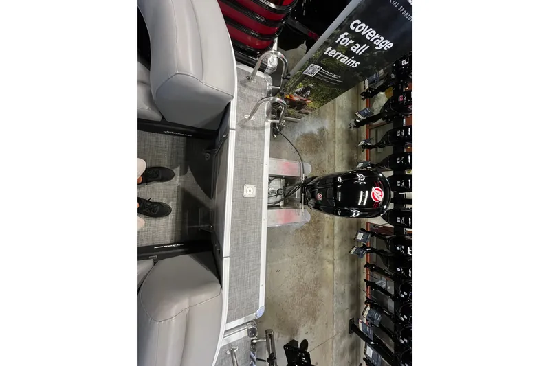 Slide: The Image of 2026 Sun Tracker Party Barge 22 DLX interior with seating and motor display. - 12