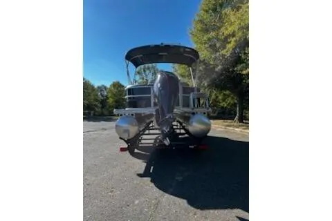 Slide: The Image of 2026 Sun Tracker Party Barge 20 DLX pontoon boat on trailer, parked outdoors. - 3