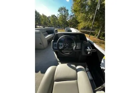 Slide: The Image of 2026 Sun Tracker Party Barge 20 DLX interior with steering wheel and seating. - 5