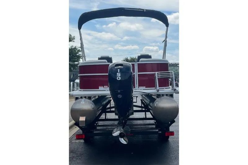 Slide: The Image of 2026 Sun Tracker Party Barge 22 DLX pontoon boat with 150 HP engine, rear view. - 102