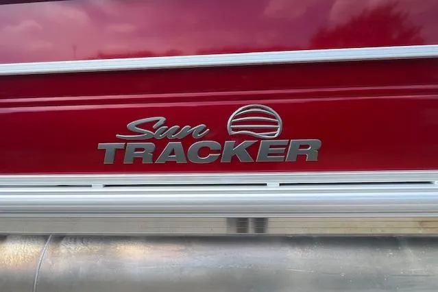 Slide: The Image of Sun Tracker Party Barge 22 DLX 2026 logo on red background. - 103