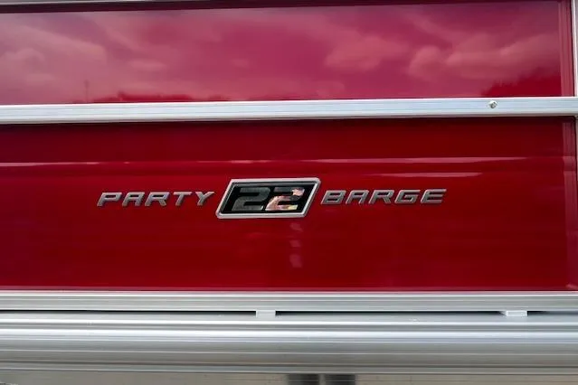 Slide: The Image of 2026 Sun Tracker Party Barge 22 DLX logo on red background. - 104
