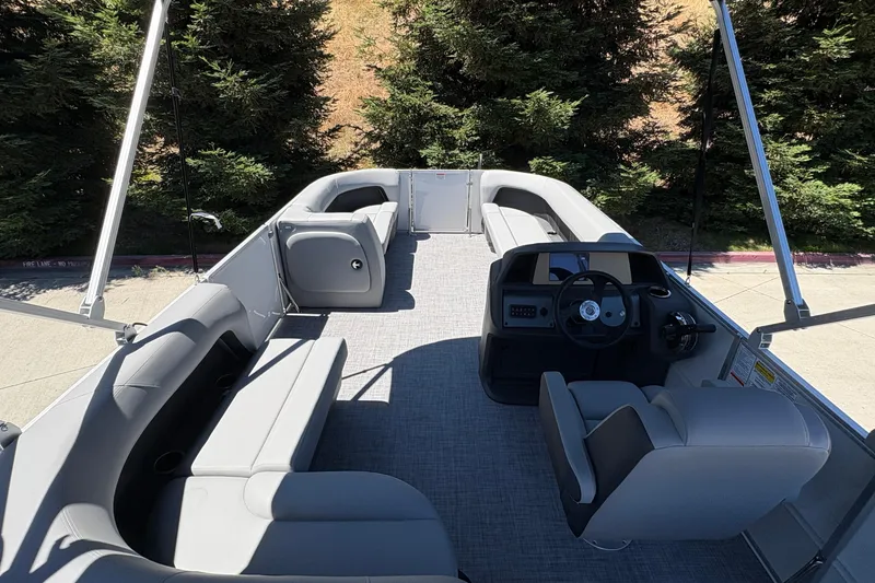 Slide: The Image of 2026 Sun Tracker Party Barge 18 DLX interior with spacious seating and modern helm. - 19