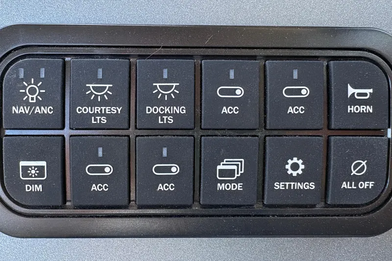 Slide: The Image of Control panel of 2026 Sun Tracker Party Barge 18 DLX with various switches and buttons. - 29