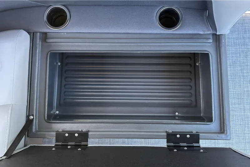 Slide: The Image of Open storage compartment on 2026 Sun Tracker Party Barge 18 DLX with cup holders. - 36