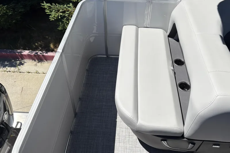 Slide: The Image of 2026 Sun Tracker Party Barge 18 DLX interior with cushioned seating and cup holders. - 22