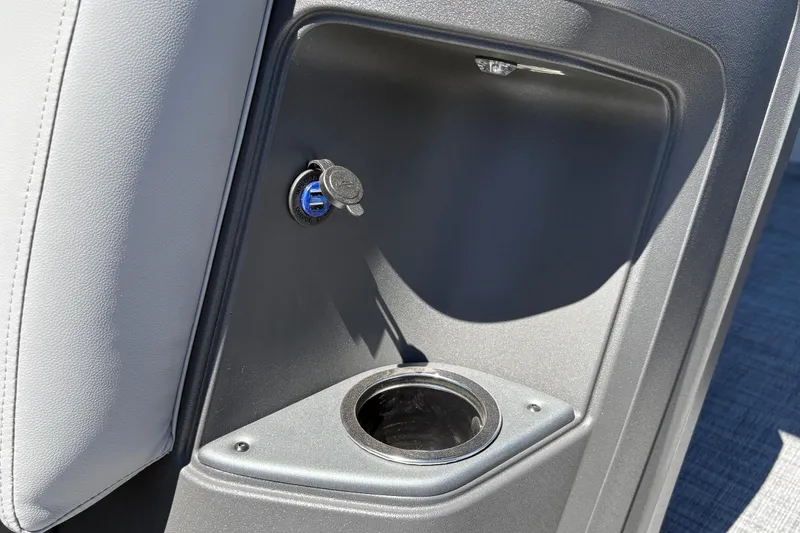 Slide: The Image of 2026 Sun Tracker Party Barge 18 DLX interior with USB port and cup holder. - 25