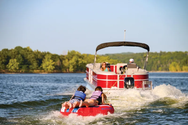 Slide: The Image of 2026 Sun Tracker Party Barge 22 DLX interior with gray seating and cup holders. - 4