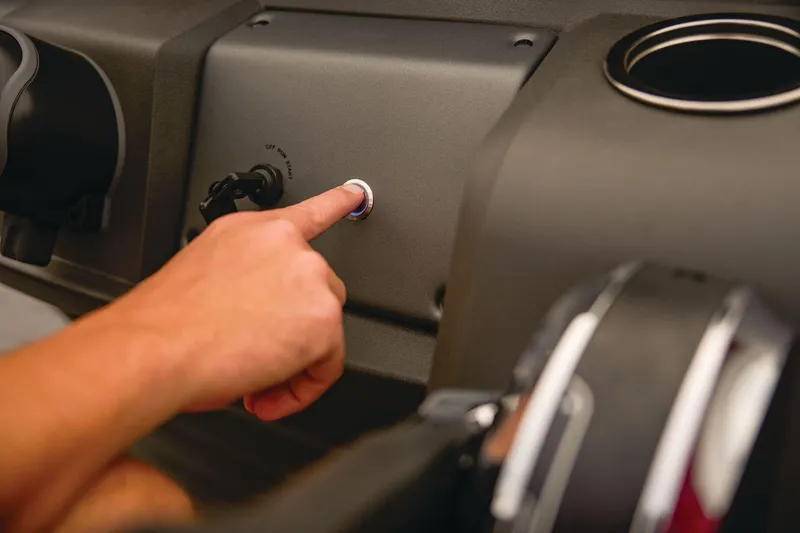 Slide: The Image of 2026 Sun Tracker Party Barge 18 DLX steering console with modern controls and cup holder. - 10