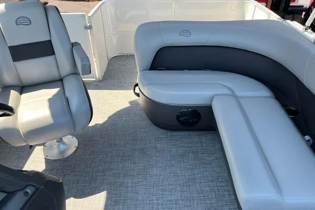 Slide: The Image of 2026 Sun Tracker Party Barge 18 DLX interior with gray seating and carpeted floor. - 5