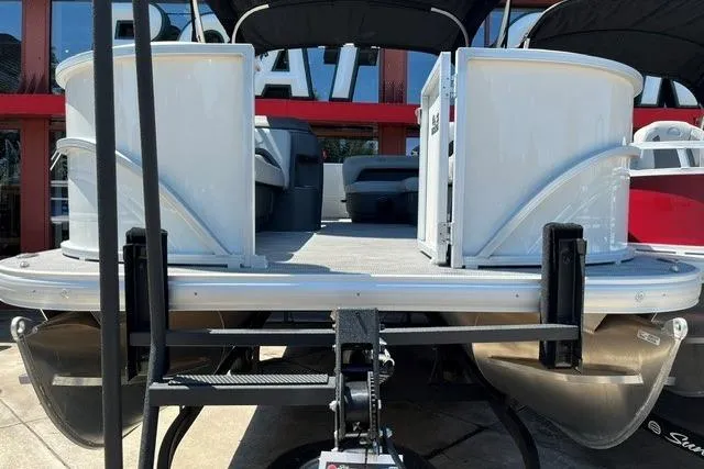 Slide: The Image of 2026 Sun Tracker Party Barge 18 DLX pontoon boat, rear view, showcasing deck and seating. - 2