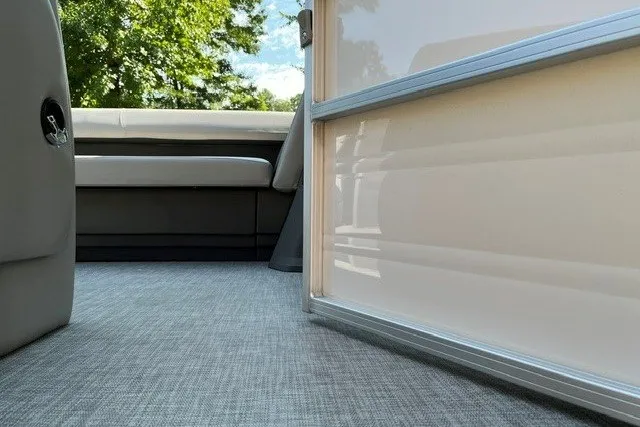Slide: The Image of 2026 Sun Tracker Party Barge 18 DLX interior with seating and flooring detail. - 86