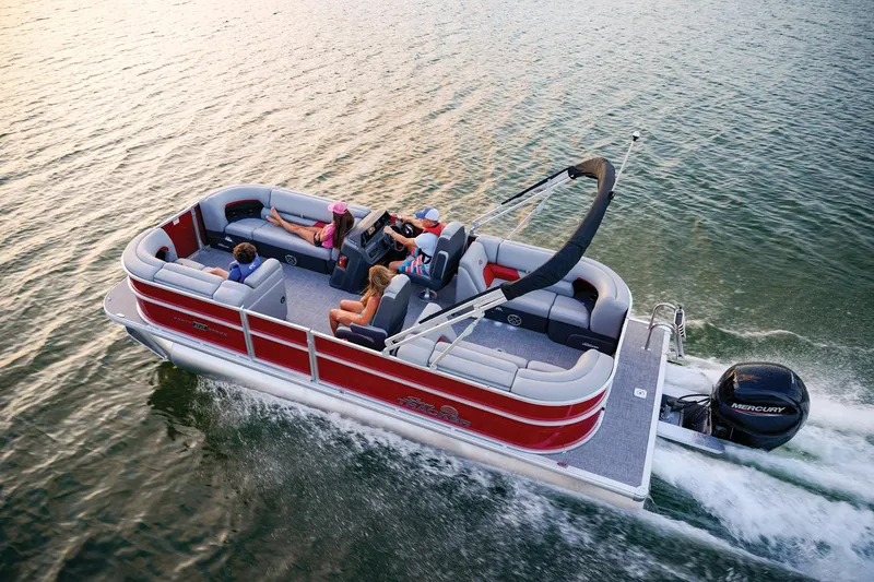 The Image of 2026 Sun Tracker Party Barge 22 DLX pontoon boat on trailer, red and silver design. - 0