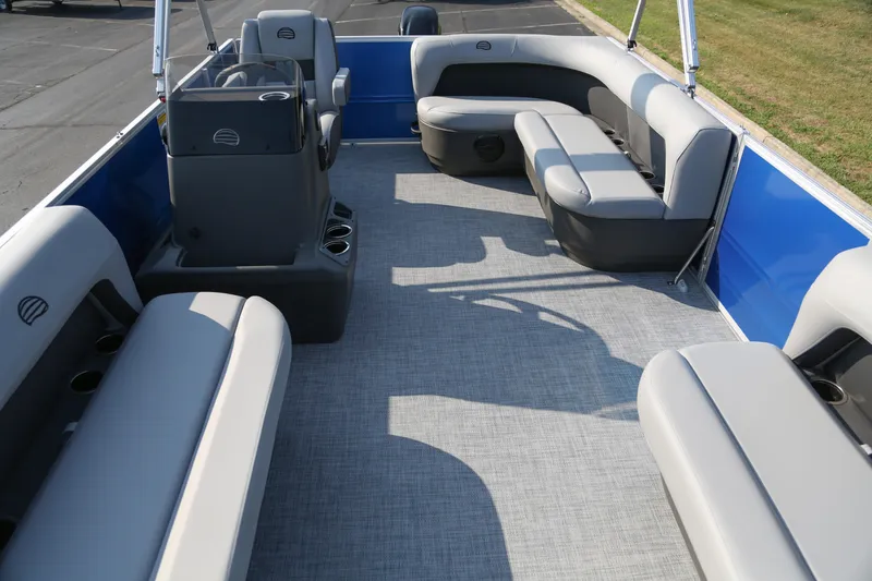 Slide: The Image of 2026 Sun Tracker Party Barge 16 DLX interior with gray seating and blue accents. - 2