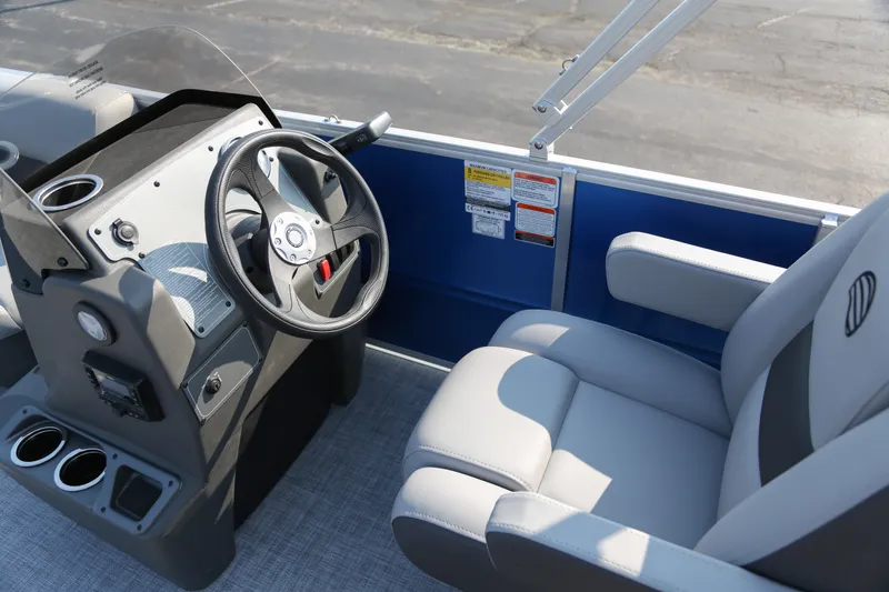 Slide: The Image of 2026 Sun Tracker Party Barge 16 DLX helm with steering wheel and comfortable seating. - 3