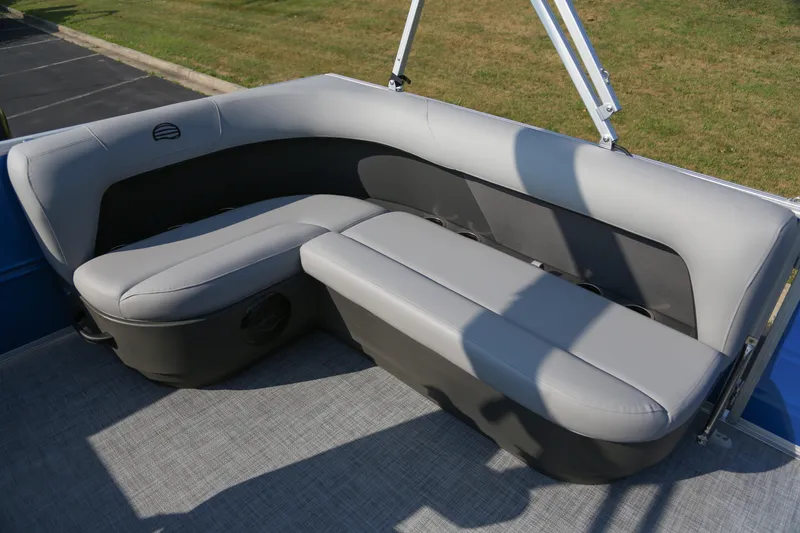 Slide: The Image of 2026 Sun Tracker Party Barge 16 DLX, featuring comfortable gray seating on a pontoon boat. - 5