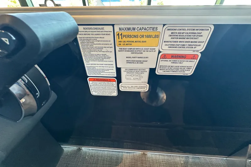 Slide: The Image of Control panel of 2026 Sun Tracker Party Barge 22 XP3 with safety and capacity labels. - 15