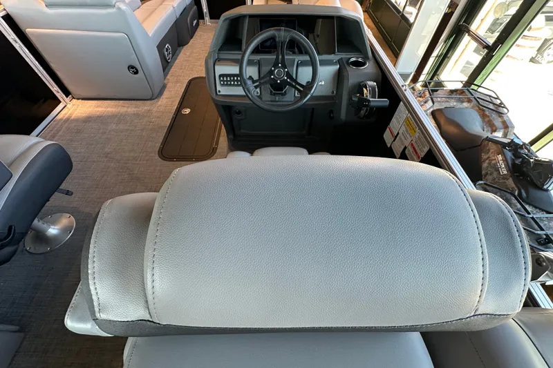 Slide: The Image of Interior view of 2026 Sun Tracker Party Barge 22 XP3 with steering console and seating. - 14